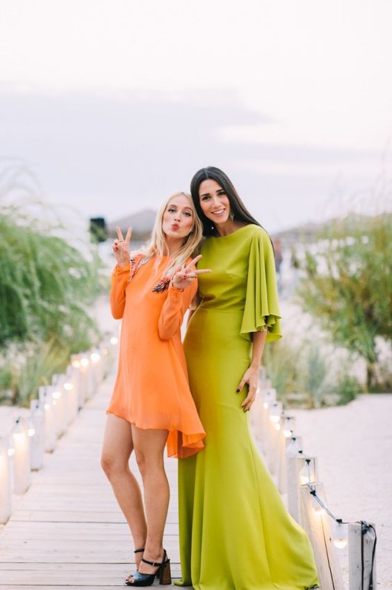 neon green ,axi dress with long ruffled sleeves ad a train and a short orange dress with long sleeves