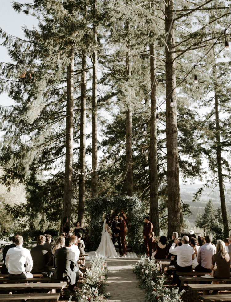 The wedding aisle was lined up with lush greenery and blooms, too