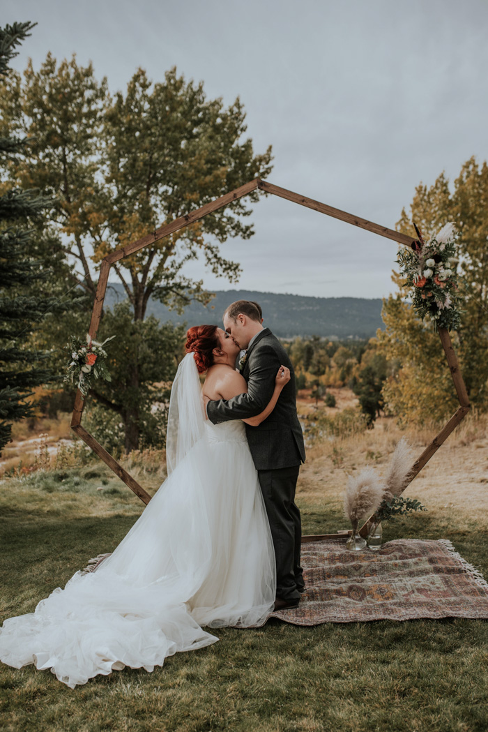 The wedding arch was a geometric one, decorated with greenery and blooms