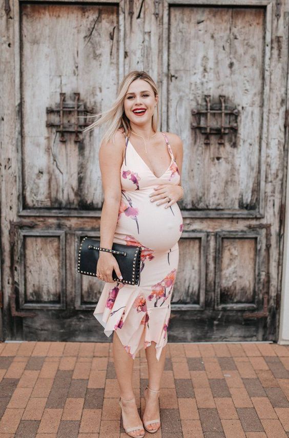 a blush floral print midi dress with a ruffled skirt, spaghetti straps, a deep neckline, nude heels and a catchy bag