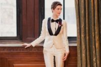 07 an elegant creamy tuxedo with black lapels, a white shirt and a black bow tie plus black heels is a stylish statement