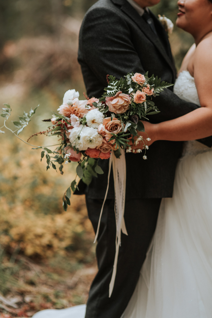 The wedding bouquet was very tender, with dusty pink and white blooms and lush greenery