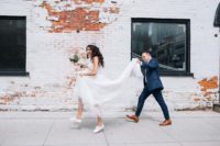 08 a romantic lace embellished wedding gown with a train and white sneakers for a modern bridal outfit