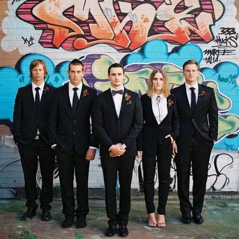 everyone wearing black suits, a bolo tie for the girl. ties and bow ties for the guys and sexy heels for the lady