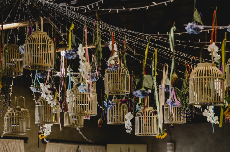 There were many faux birdcages hanging overhead and decorated with fresh blooms