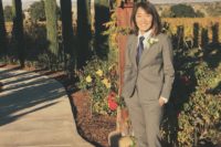 09 a grey suit with cropped pants, a navy tie, black heels and a floral boutonniere for an elegant look