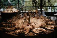 10 The wedding tablescapes were done with bottles as vases, simple blooms and greenery and elegant glasses and porcelain