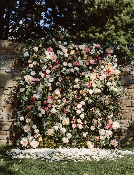 a stunning lush floral backdrop of textural greenery, neutral and pink flowers is a timeless idea