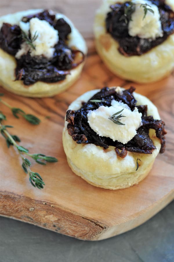onion confit tartlets are a savory wine infused appetizer with a dollop of vegan ricotta and fresh thyme