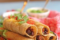11 baked taquitos with smoky sweet potatoes are filled with black beans and are a crowd pleasing appetizer