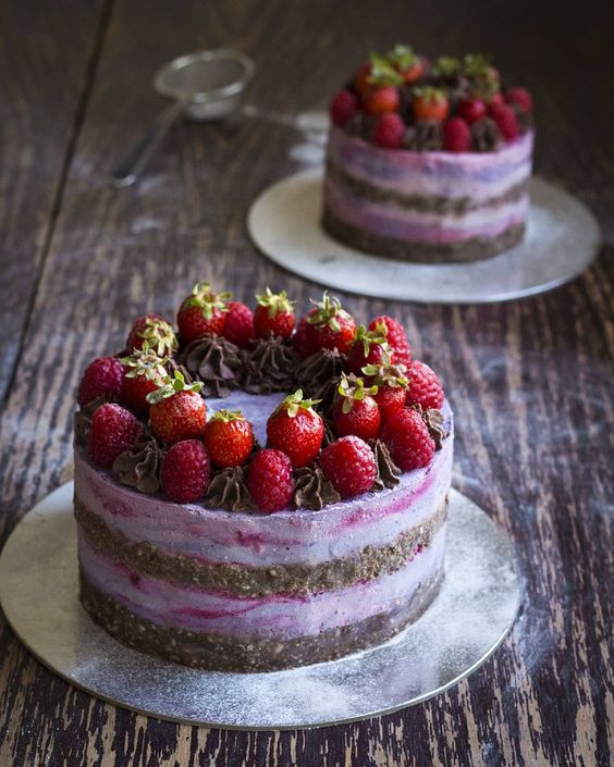 a berry ombre vegan wedding cake with a chocolate brownie layer topped with fresh strawberries