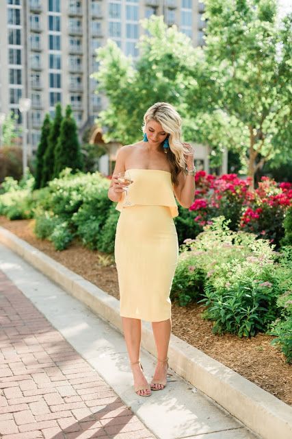 a sunny yellow strapless midi dress plus nude heeled sandals and turquoise tassel earrings