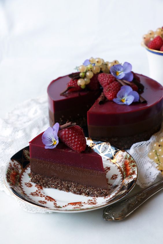 a chocolate raspberry Bavarian cake that is gluten-free and gluten-free with berries and flowers on top and raspberry agar jelly
