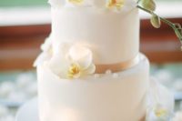 14 a classic wedding cake topped with fresh orchids and edible pearls is always a chic idea