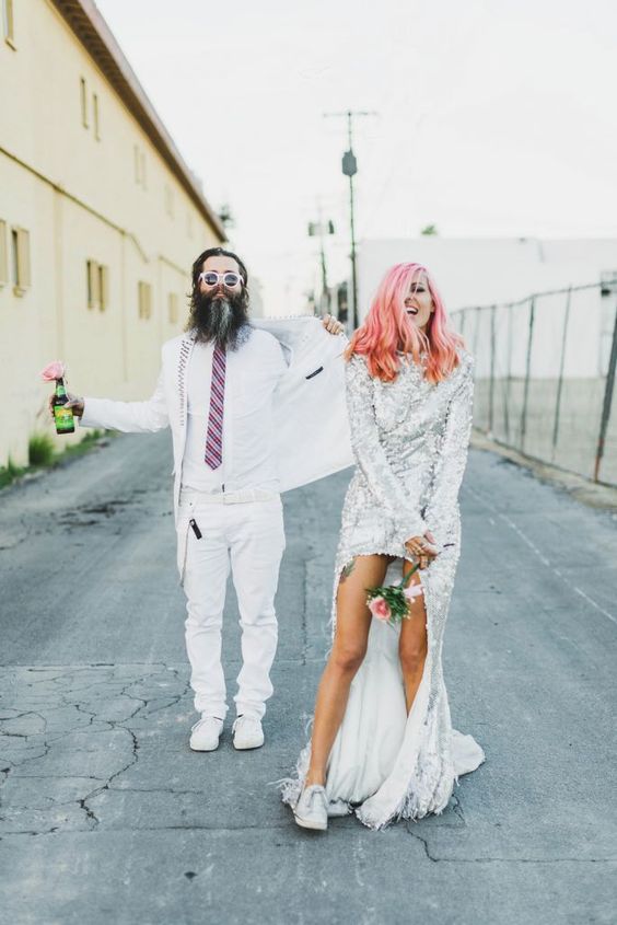 the couple wearing crazy outfits and white sneakers both to accent their cool looks even more