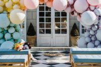 16 a pastel gradient balloon wedding arch in blue, yellow, peachy, pink and lilac plus blooms in between