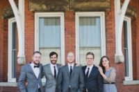 16 groomsmen wearign grey suits and a groomswoman rocking a grey dress and black heels