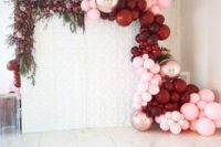 18 a beautiful wedding backdrop decorated with lush greenery and blooms on one side and burgundy, copper and pink balloons on the other