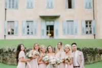 19 bridesmaids wearign pink dresses and a bridesman rocking a pink suit with a tie and a white shirt