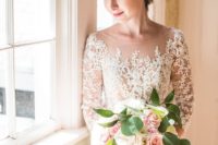 20 an illusion bateau neckline wedding dress with a lace bodice and a flowy skirt