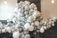 21 a dreamy white and silver balloon wedding backdrop of disco balls, moons and usual balloons