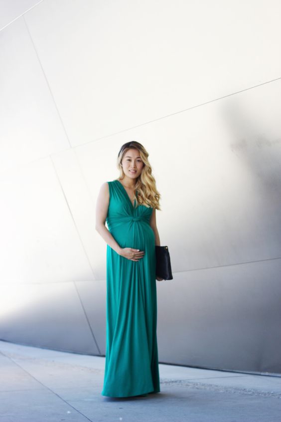 a turquoise maxi dress with a draped bodice and no sleeves plus a black clutch is an easy and cool outfit