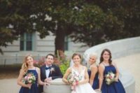 21 navy midi dresses with halter necklines match a grey suit with a navy bow tie to create an elegant party look