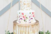 22 a trendy wedding cake combining metallic drip, handpainting and metallic leaf plus fresh blooms on top