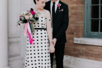 22 a very whimsy white and black A-line off the shoulder wedding gown with a lace trim plus pink shoes and statement earrings