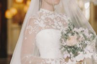 23 a romantic wedding ballgown with a high neckline, long sleeves and a matching veil