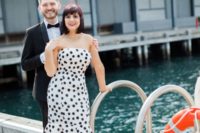 23 a whimsy black and white polka dot strapless wedding dress with a ruffled skirt paired with red shoes and a red lipstick