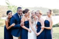 23 everyone wearing navy, strapless gowns for the girls and a navy blazer plus a tie for the groomsman