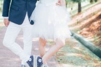 24 the bride and the groom wearing the same denim Converse sneakers for a matching look