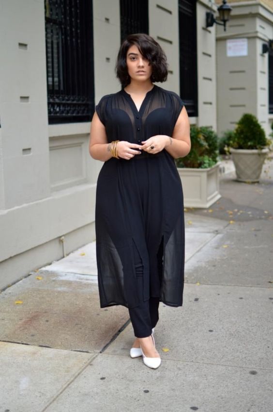 a chic look with a black strapless jusmpsuit, a sheer black overgown with buttons and white shoes