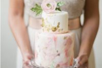26 a tender handpainted watercolor wedding cake with gold leaf and a sugar flower on top for a spring wedding