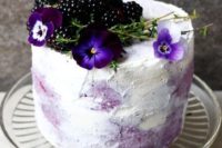 26 a wholesome gluten-free and vegan wedding cake with blueberries and blackberries and some fresh blooms on top