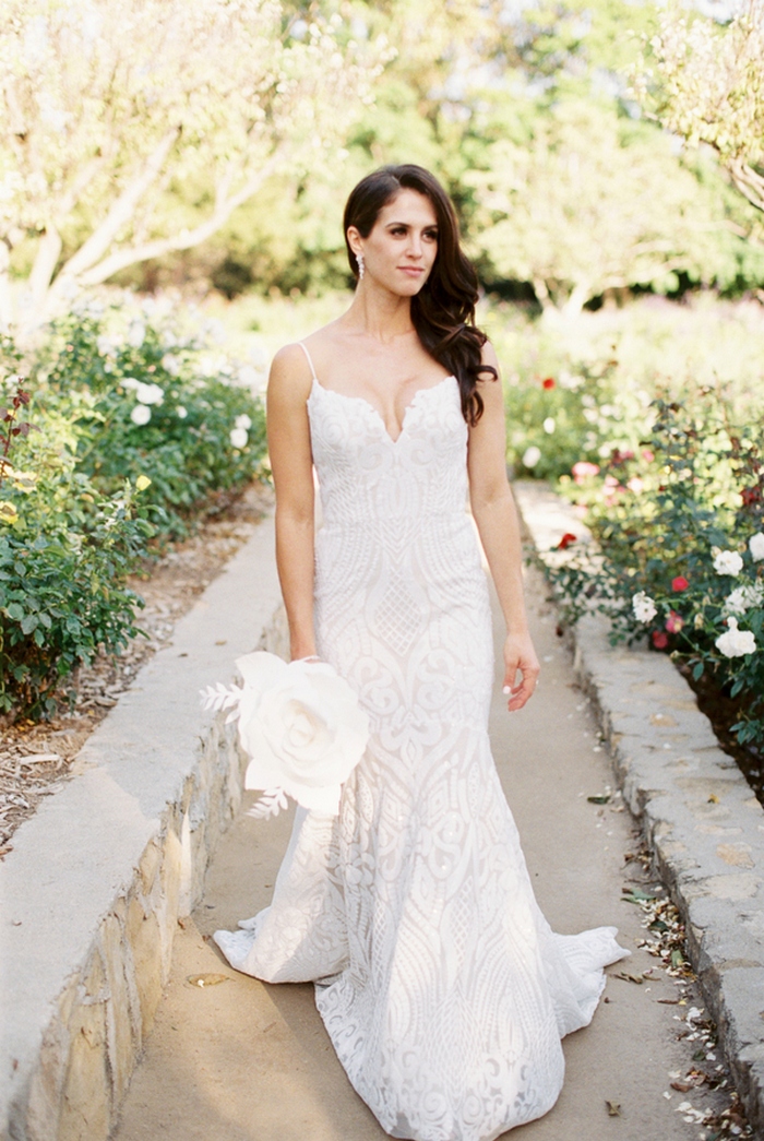  a sexy white lace sheath wedding dress with spaghetti straps and a plunging neckline