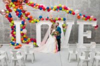 27 marquee LOVE letters decorated with super colorful balloons here and there is a veyr whimsy idea