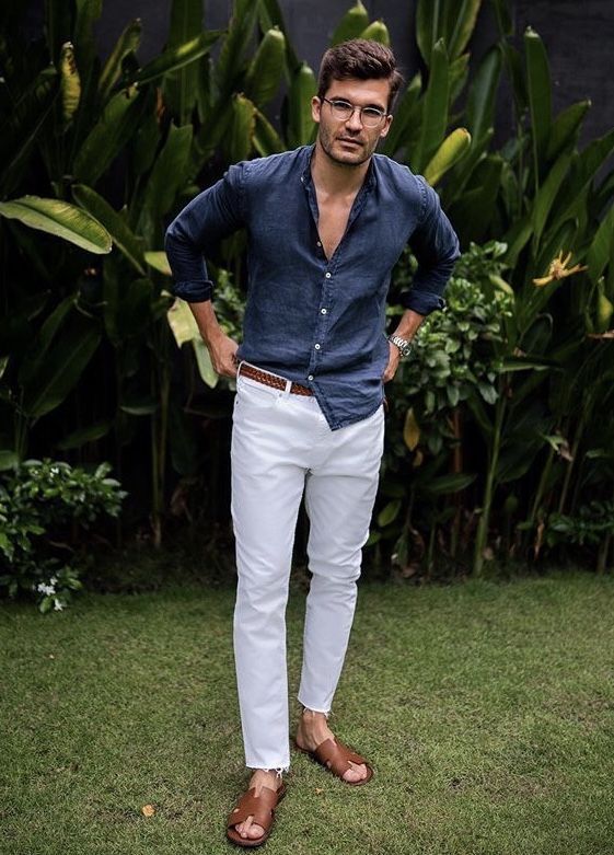 A Beach Wedding Guest Outfit With A Navy Linen Shirt White Pants A Brown Belt And Brown Sandals Is Cool And Chic 
