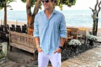 a blue shirt, white pants, neutral flip-flops are a cool and simple beach wedding guest look