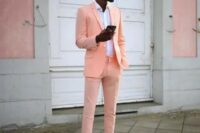 a bright summer or tropical wedding guest look with a neon orange suit, a white shirt and sneakers if you want to make a statement with color