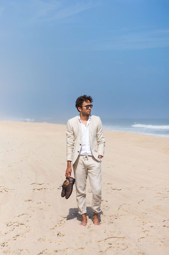 a classy beach wedding guest outfit with a neutrla linen pantsuit, a white shirt, brown shoes