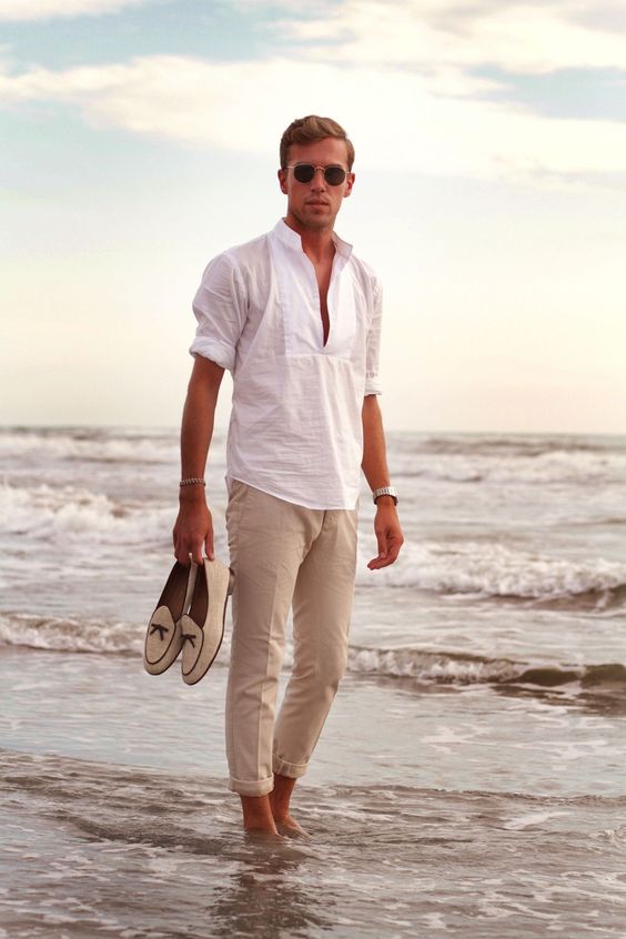 a relaxed and cool beach wedding guest look with a white linen shirt, neutral pants, creamy loafers and sunglasses