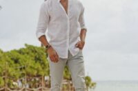 a simple beach wedding guest look with a white linen shirt, grey linen pants, brown shoes and sunglasses