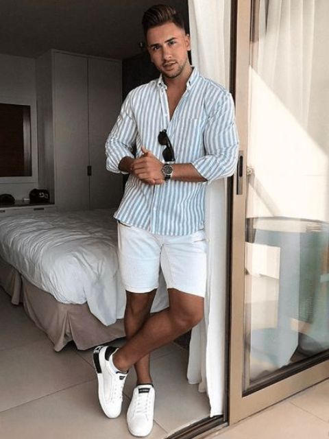 a stylish beach wedding guest look with a blue and white stripe shirt, white shorts, white sneakers is easy to repeat