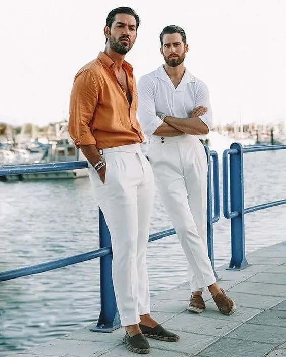 cool beach wedding guest looks with white trousers, a white and a marigold shirt, espadrilles