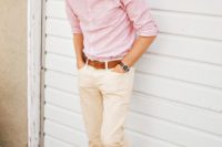 cremay pants, a pink striped shirt, brown shoes and a brown belt plus sunglasses for an effortlessly chic look
