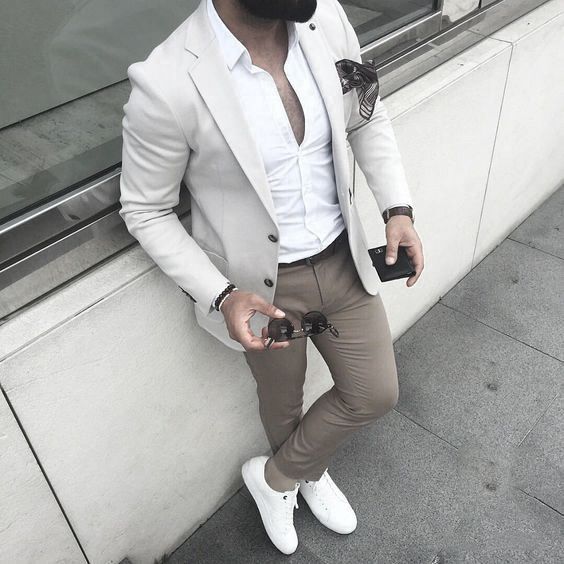 khaki chinos, a white shirt and sneakers, a creamy blazer and a pocket square for a stylish neutral look