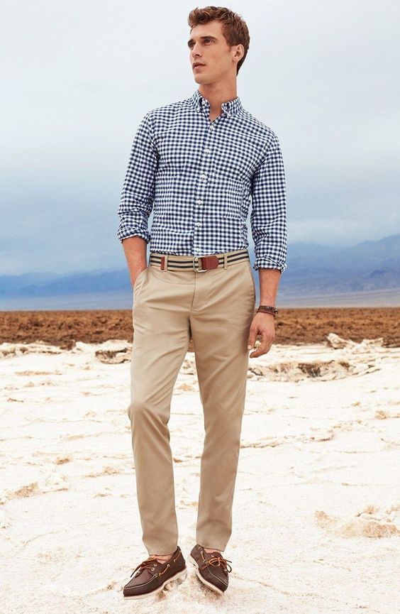 tan pants, a blue and white plaid shirt, no tie, brown moccasins for a casual beach wedding guest look