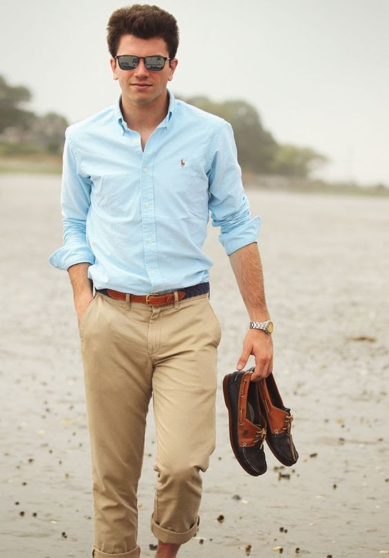 tan pants, a light blue shirt, black and brown moccasins and sunglasses are all you need for a chic look